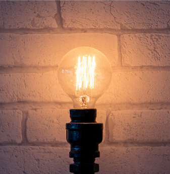 Vintage glowing light bulb on lamp stand